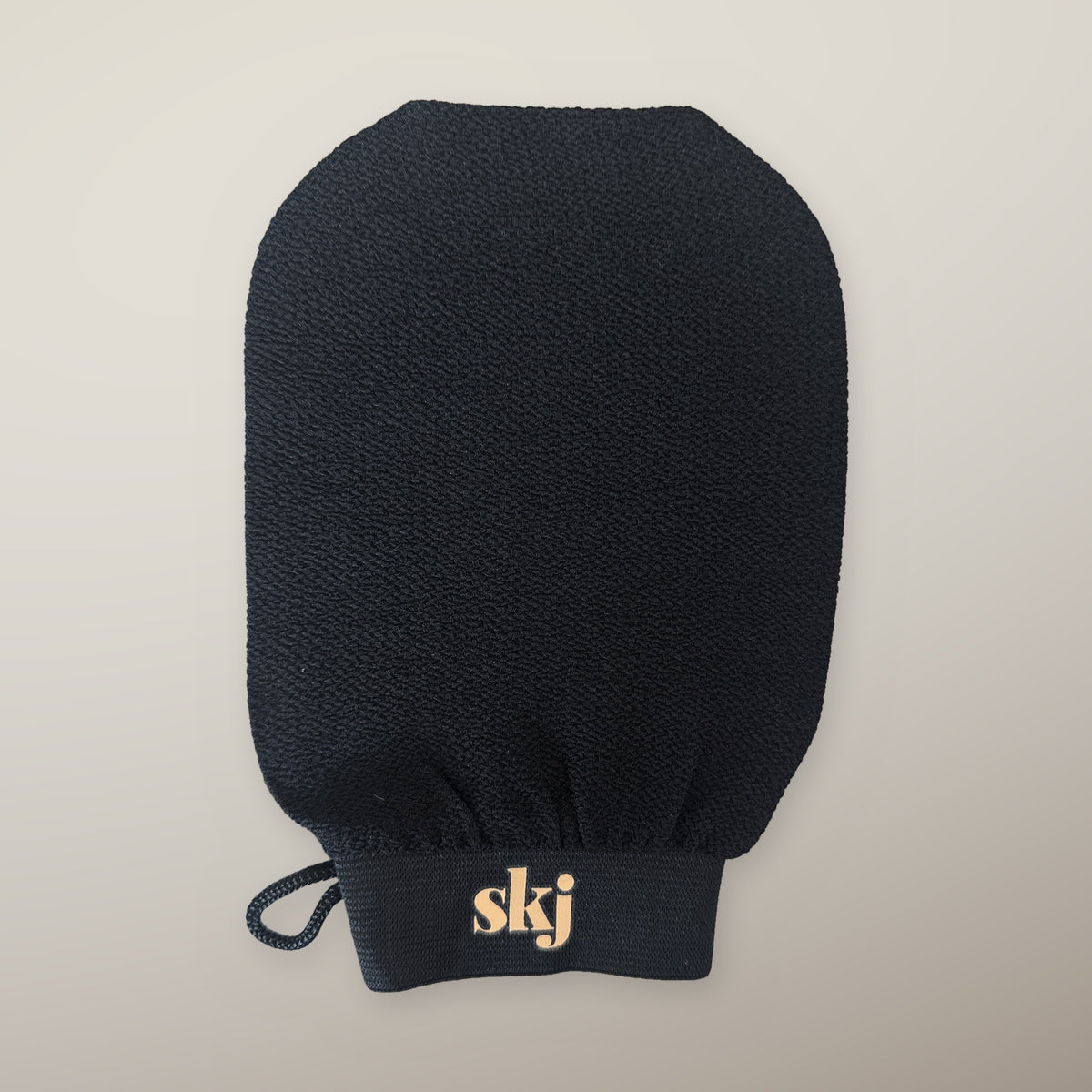 SKJ DRY MITT — black exfoliating mitt with skj logo on the cuff